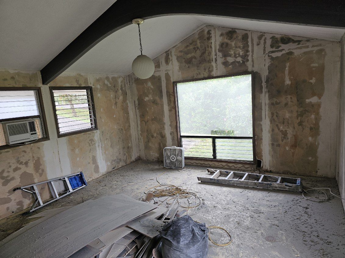 The back of a house with a lot of windows and a door.