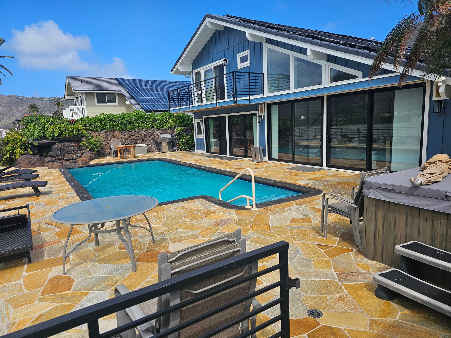 A large house with a large swimming pool in front of it