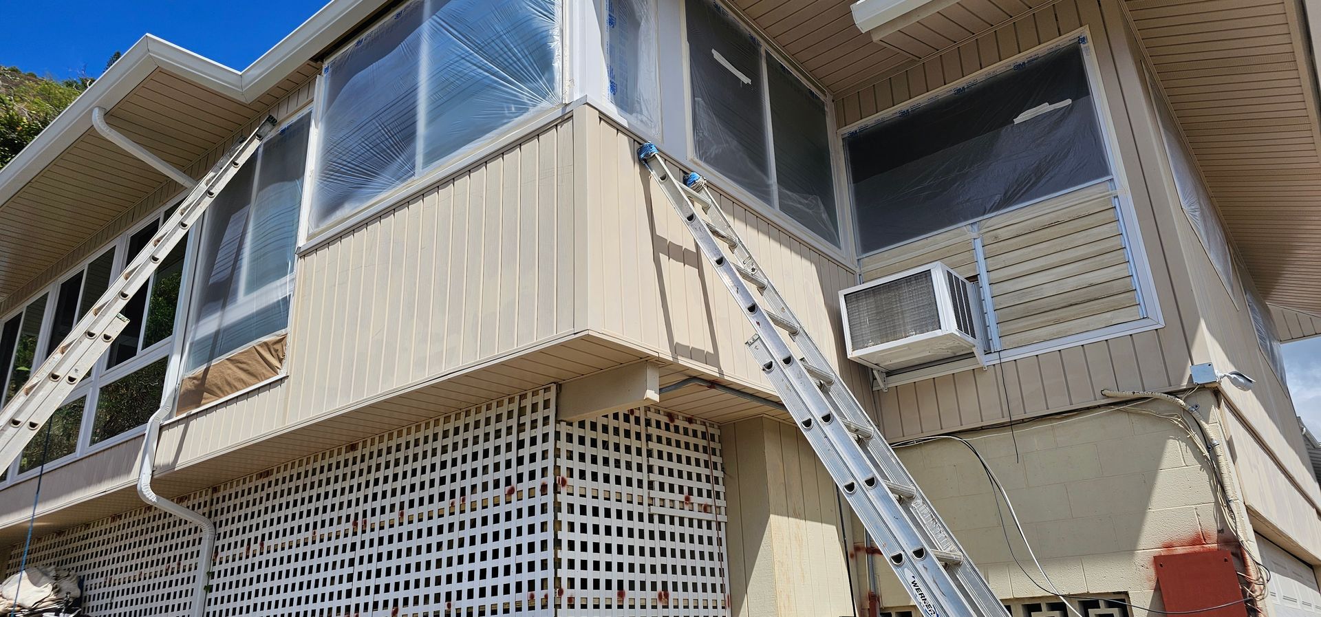 A house with a ladder attached to the side of it.