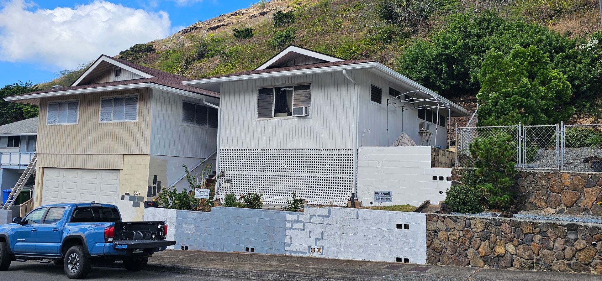 A house with a lot of windows and a gutter on the side of it.