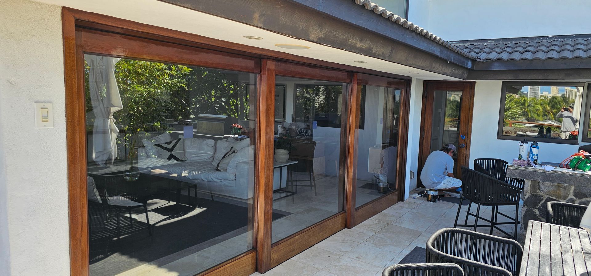 A large patio with sliding glass doors and a table and chairs.