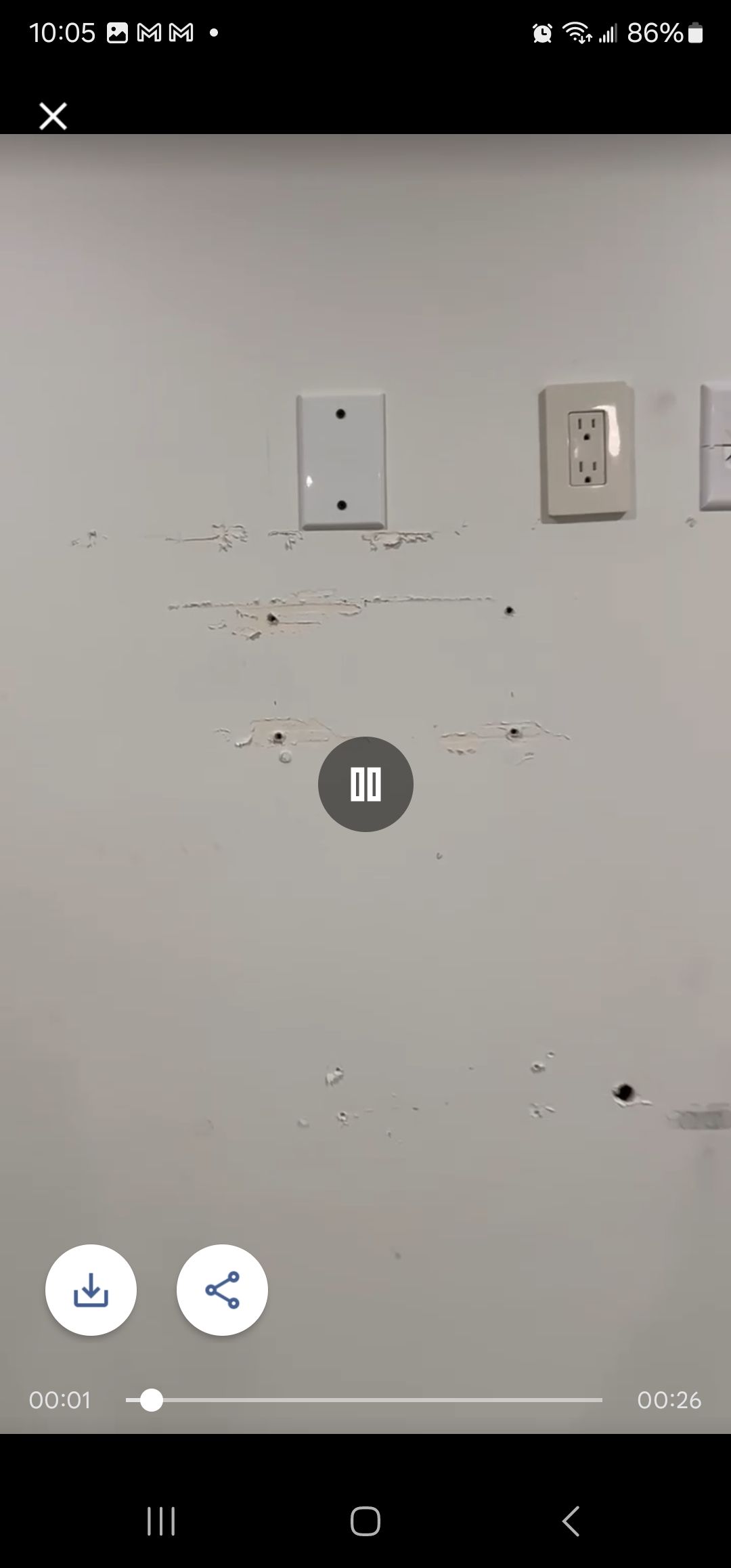 A cell phone is taking a picture of a wall.