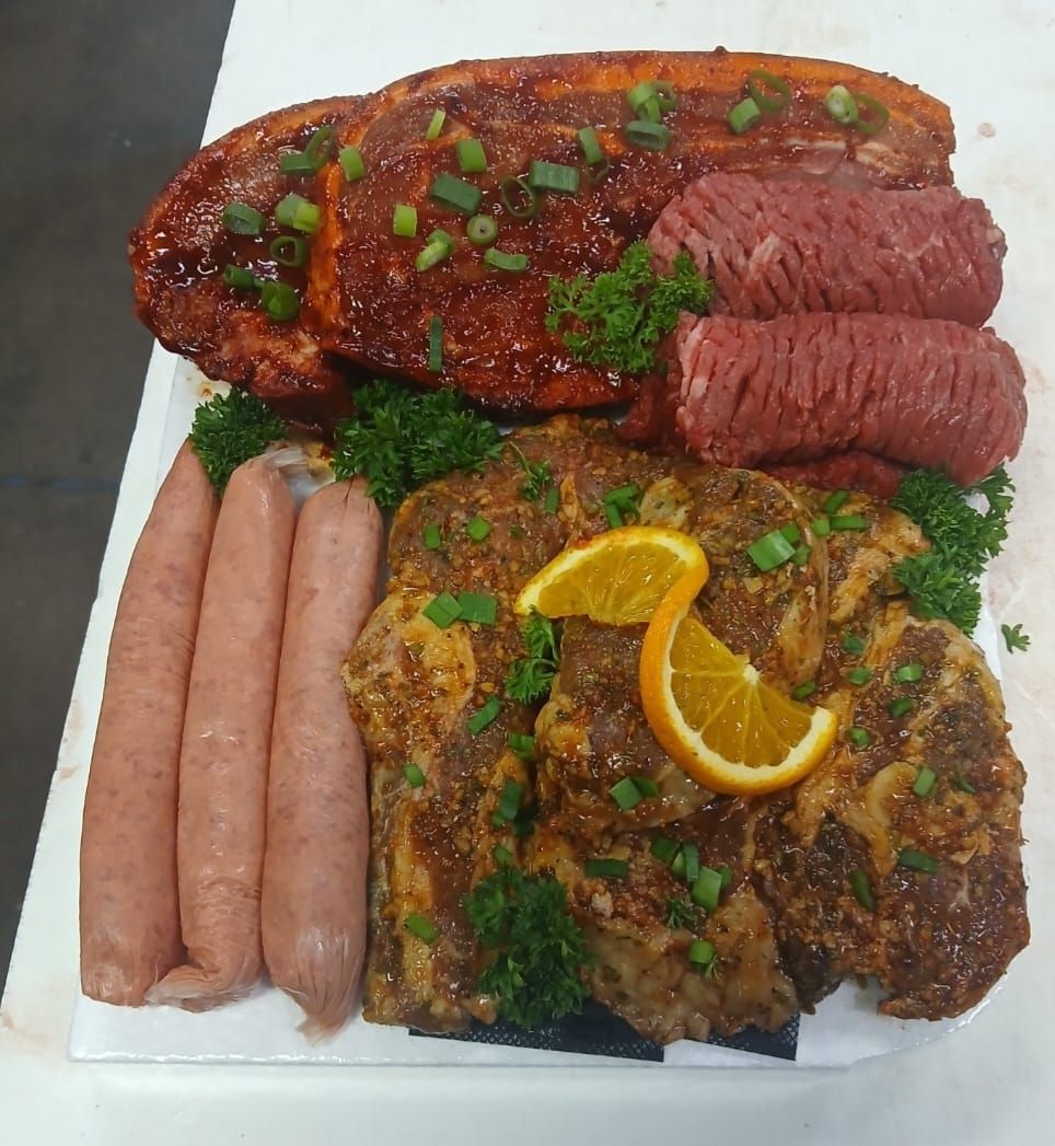 A Plate of Meat and Sausages With an Orange Slice on Top — Multy Cut Meats In Yorkeys Knob, QLD