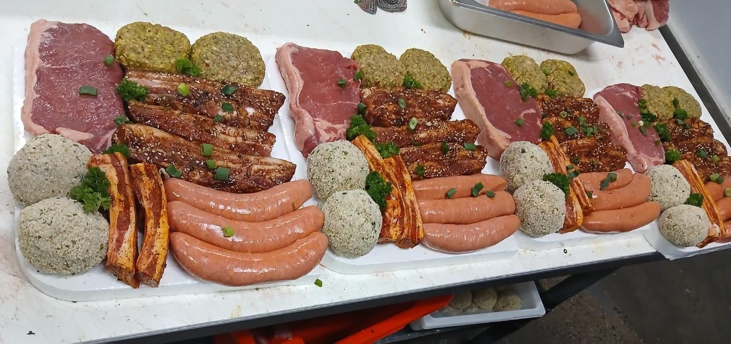 A Tray of Meat and Sausages on a Table — Multy Cut Meats In Yorkeys Knob, QLD