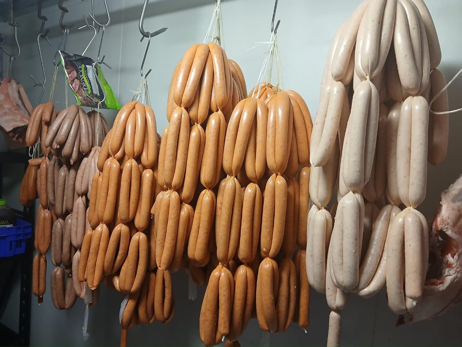 A Bunch of Sausages Are Hanging From Hooks in a Room — Multy Cut Meats In Yorkeys Knob, QLD