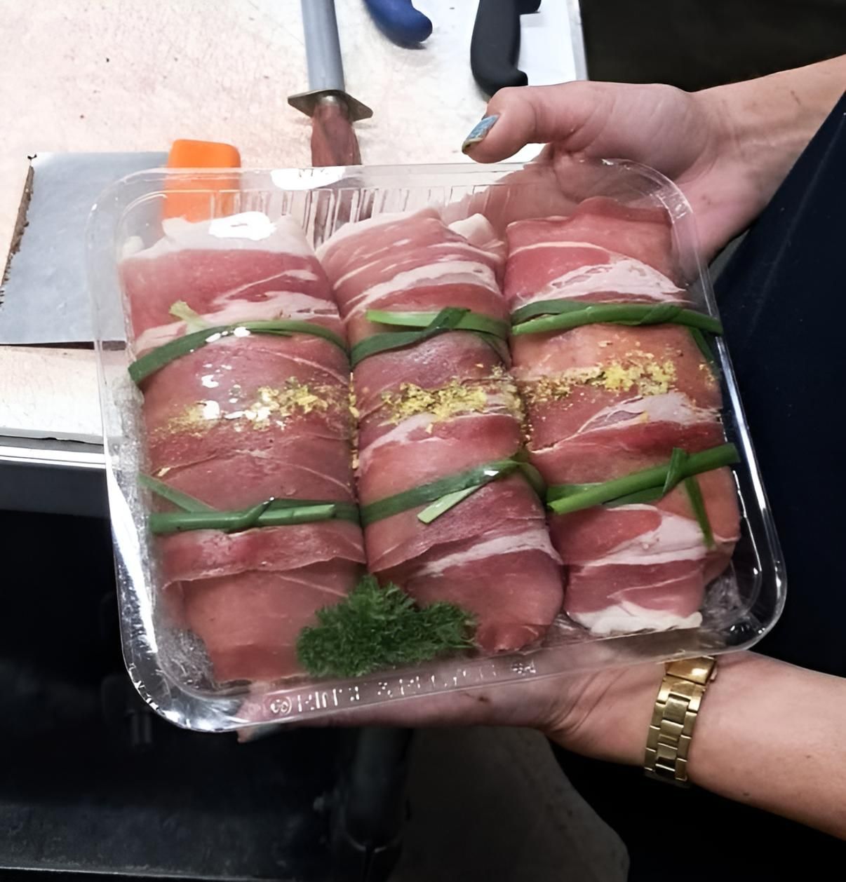 A Person is Holding a Tray of Meat Wrapped in Bacon — Multy Cut Meats In Yorkeys Knob, QLD