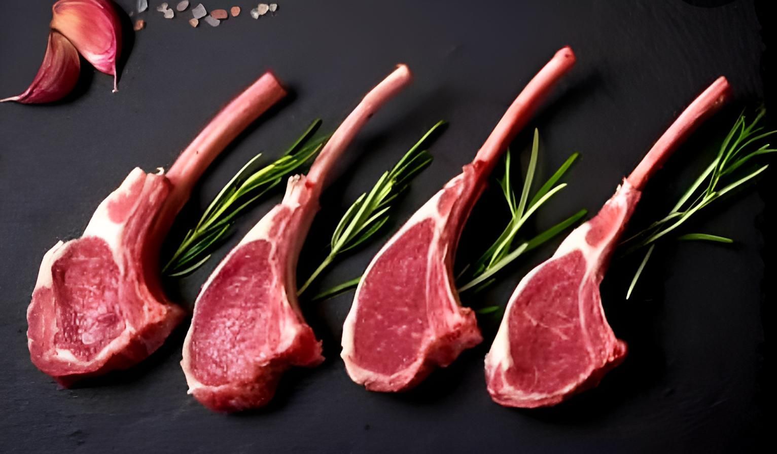 A Row of Lamb Chops With Rosemary and Garlic on a Black Surface — Multy Cut Meats In Yorkeys Knob, QLD