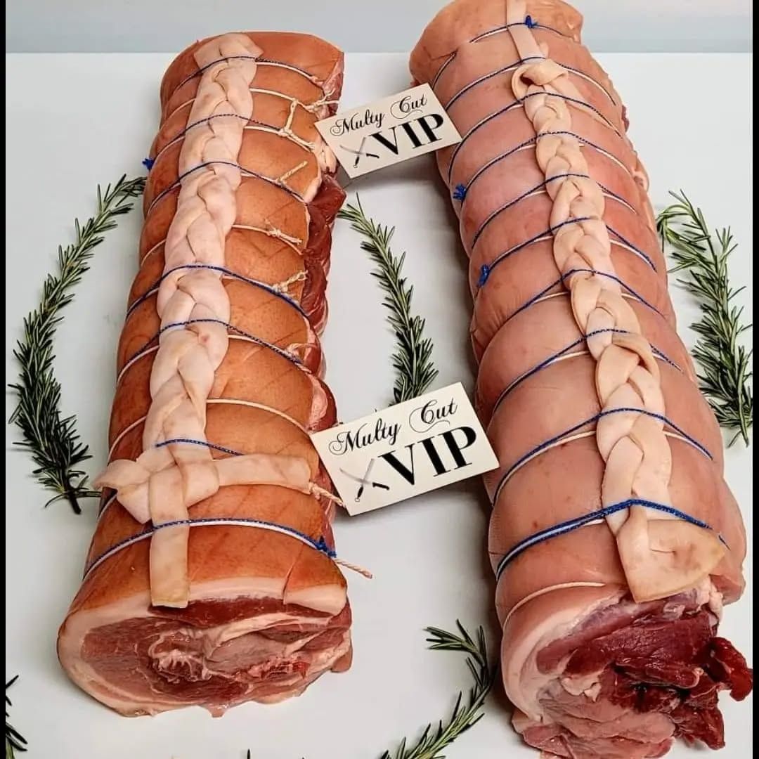 Two Rolls of Pork Are Sitting on a White Table — Multy Cut Meats In Yorkeys Knob, QLD