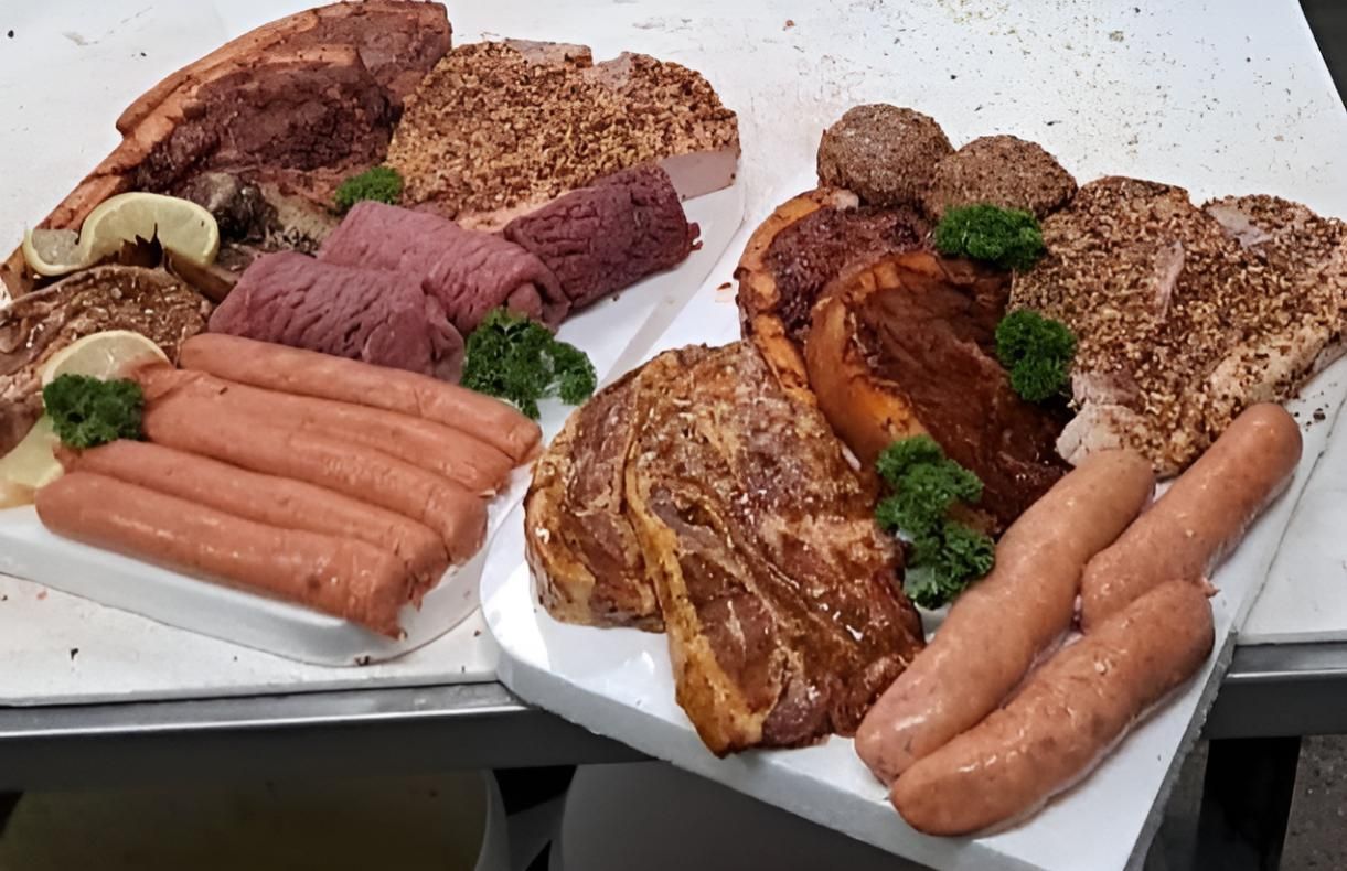 A Tray of Meat and Sausages on a Table — Multy Cut Meats In Yorkeys Knob, QLD