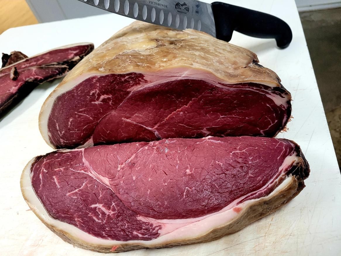 A Large Piece of Meat is Cut in Half on a Cutting Board — Multy Cut Meats In Yorkeys Knob, QLD