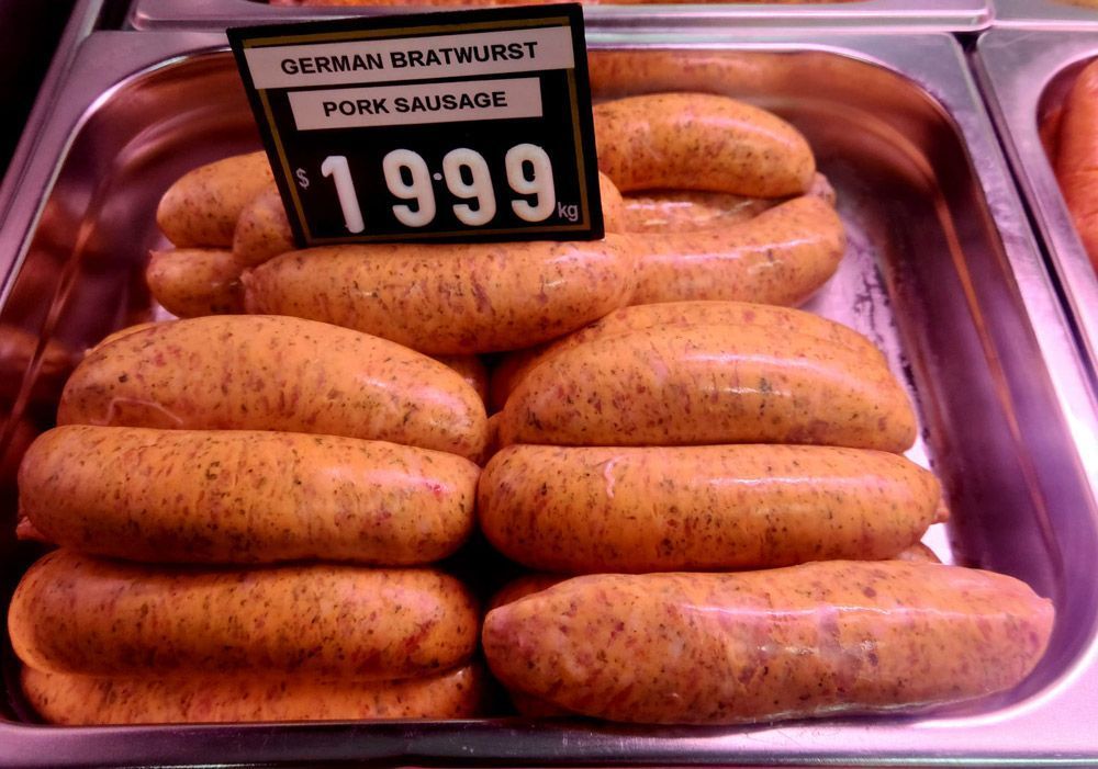 A Tray of German Bratwurst Pork Sausages With a Sign That Says 1999 — Multy Cut Meats In Yorkeys Knob, QLD