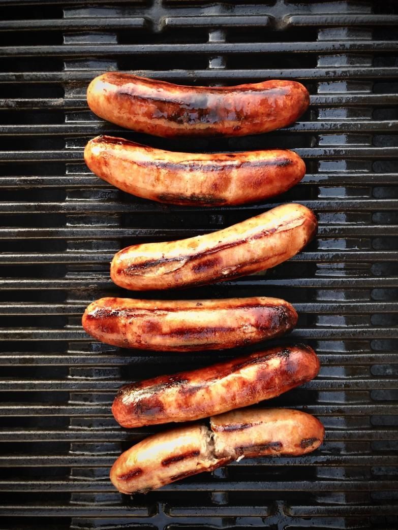 A Row of Sausages Are Cooking on a Grill — Multy Cut Meats In Yorkeys Knob, QLD