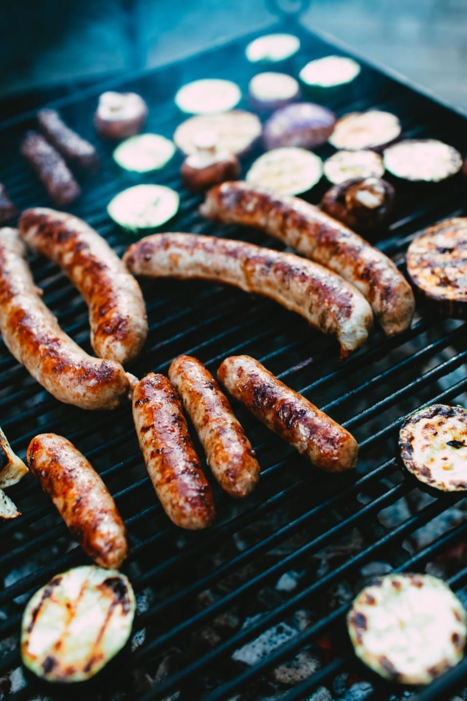 Sausages and Vegetables Are Cooking on a Grill — Multy Cut Meats In Yorkeys Knob, QLD