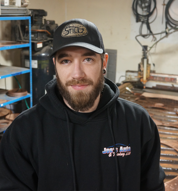 A man with a beard wearing a stillz hat
