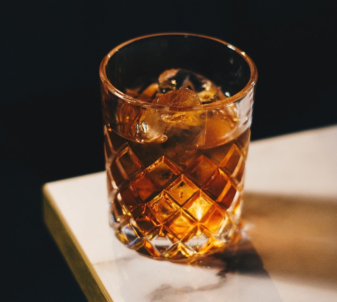 A woman is hugging another woman in a group of people sitting in chairs.