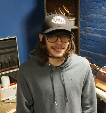 A man wearing a hat with the word still on it