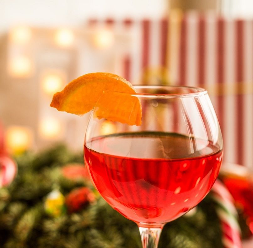 A woman is hugging another woman in a group of people sitting in chairs.