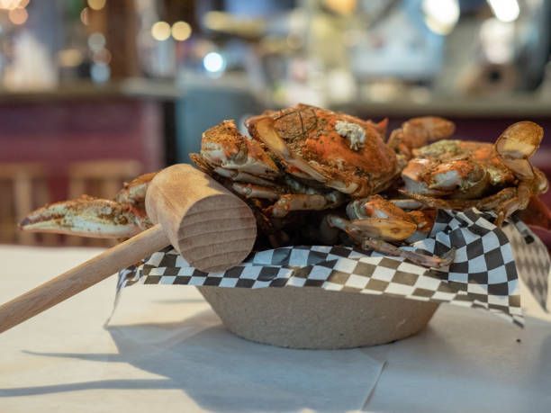 A Bowl Of Crabs And A Wooden Mallet On A Table — Conway, SC — Graham Seafood Supplies Inc.
