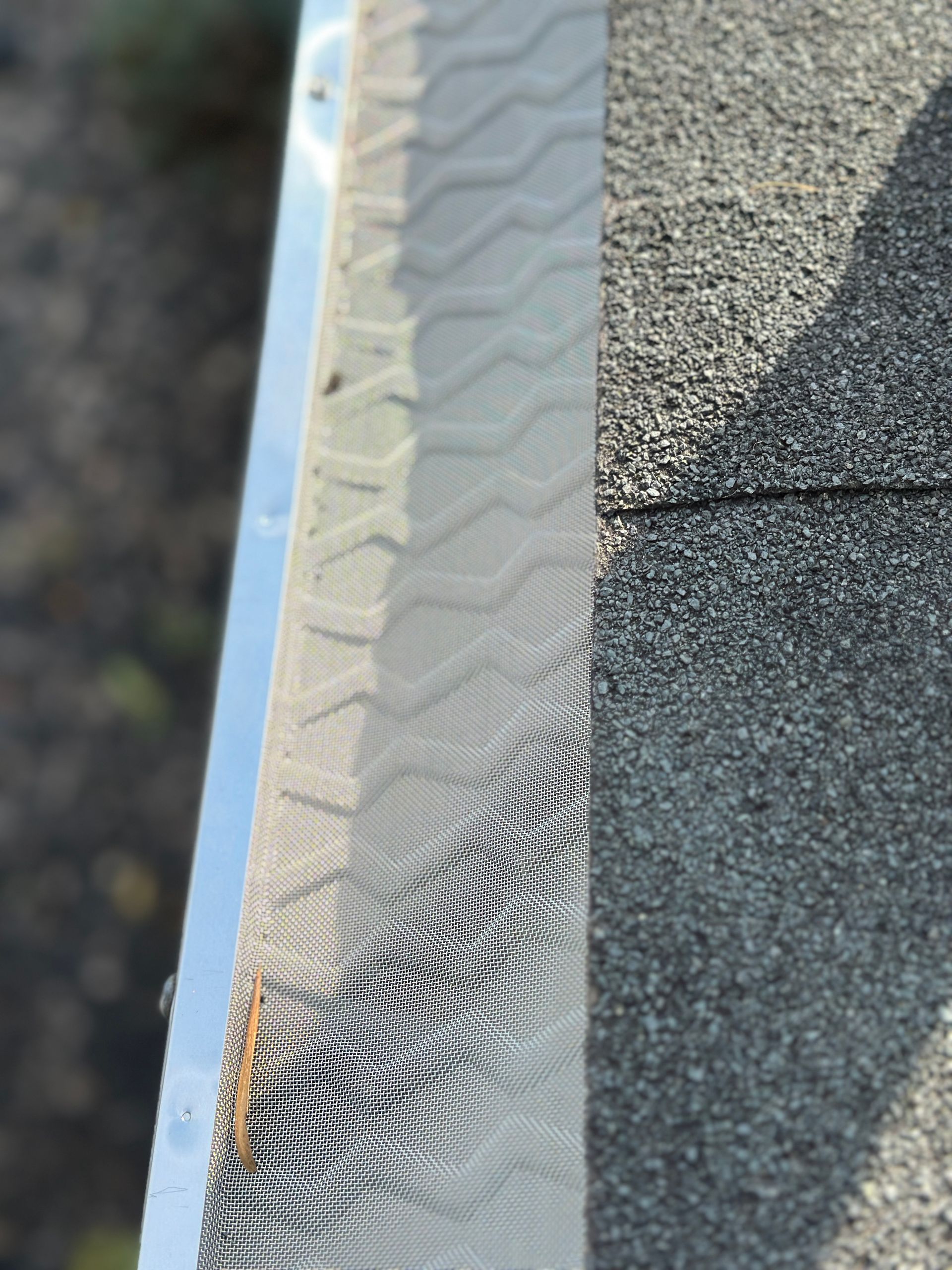 A close up of a metal gutter on a roof.