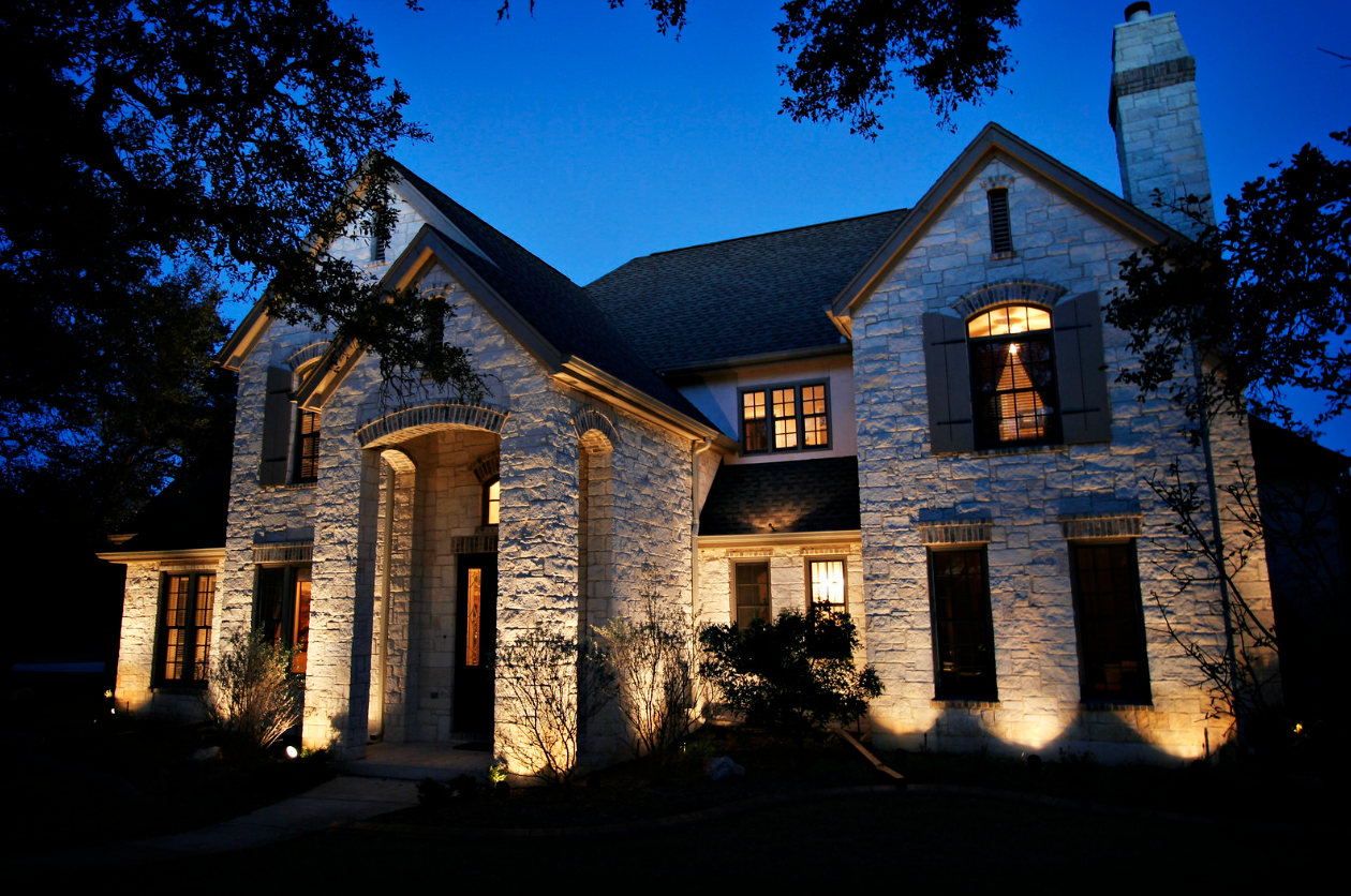 A large brick house is lit up at night in Nashville