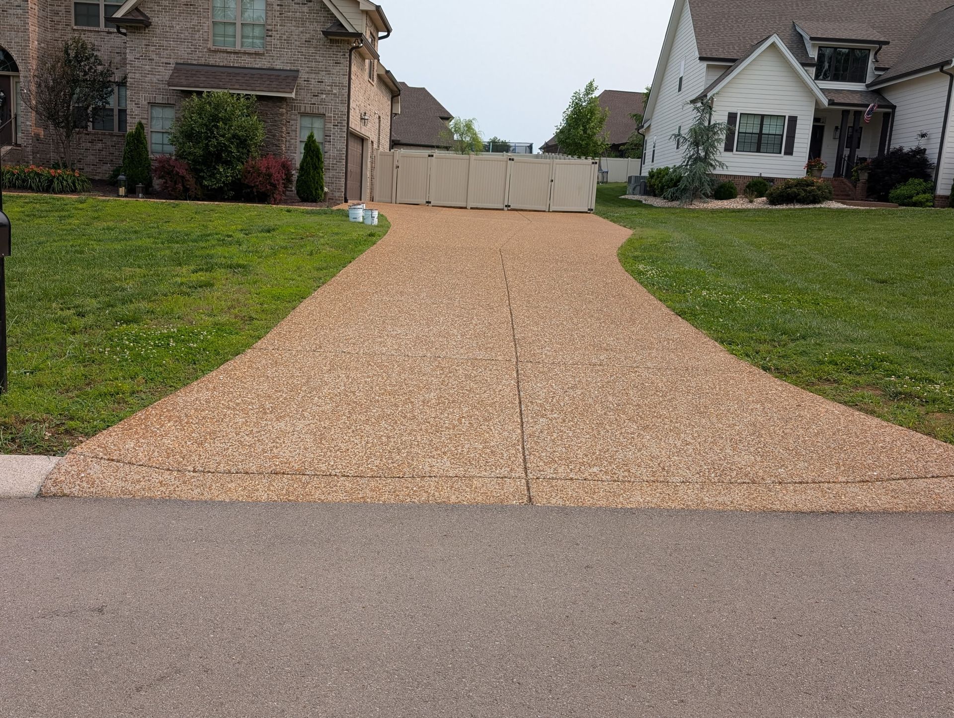 A driveway leading to a house in a residential neighborhood.