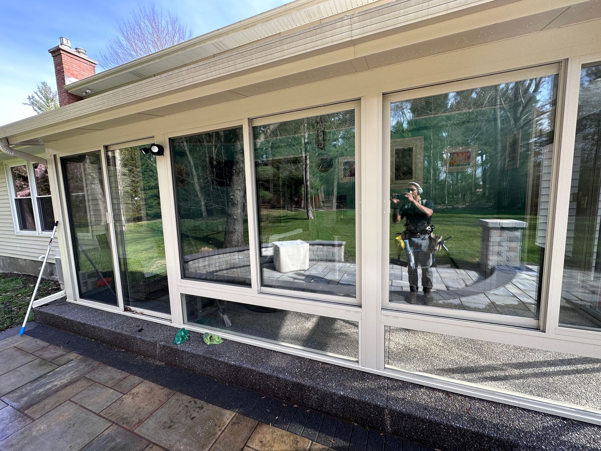 A man is cleaning the windows of a house.