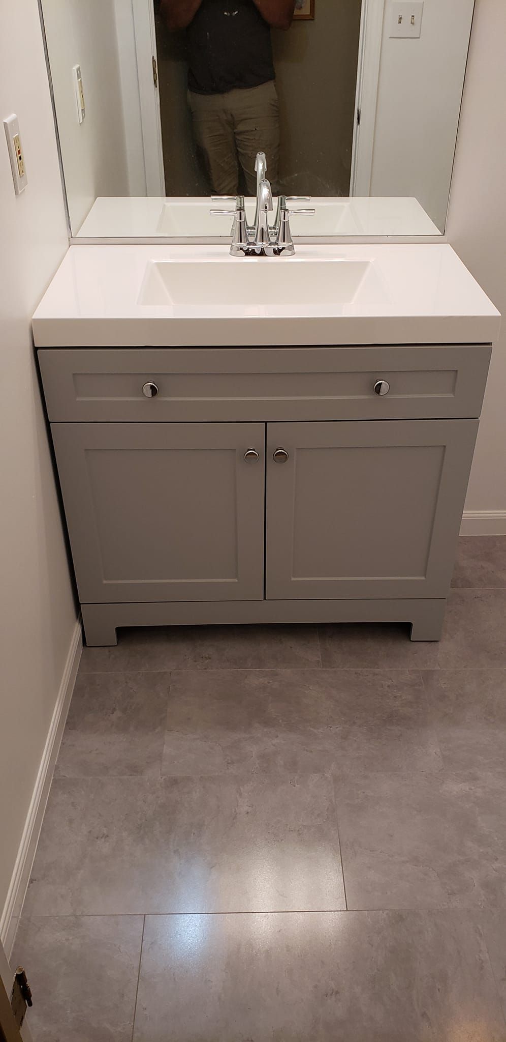 A bathroom vanity with a sink and a mirror.