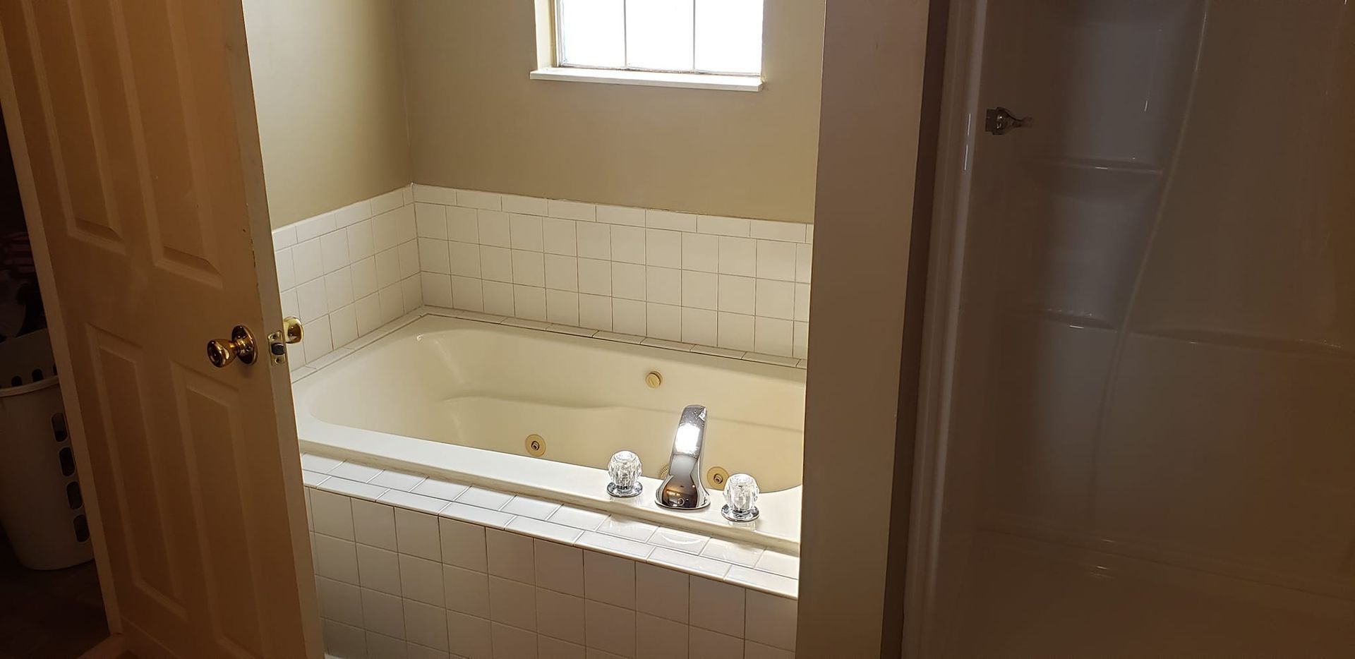 A bathroom with a jacuzzi tub and a shower.