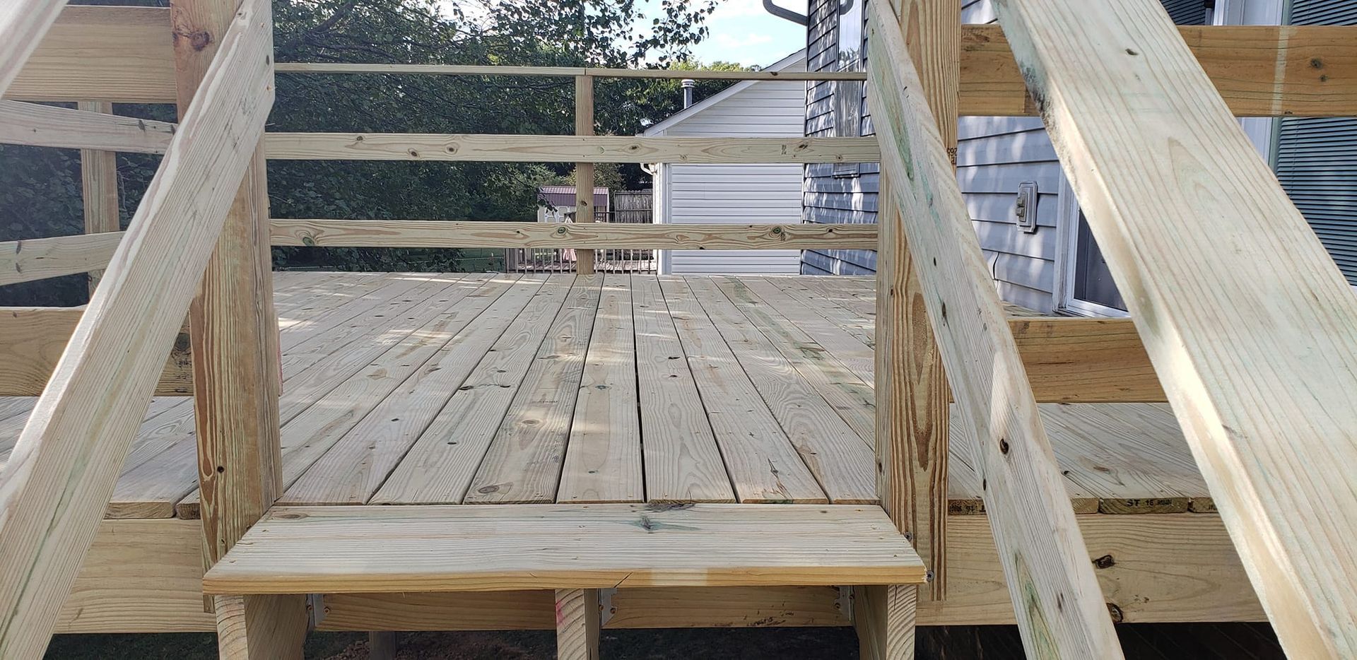 A wooden deck with stairs leading up to it