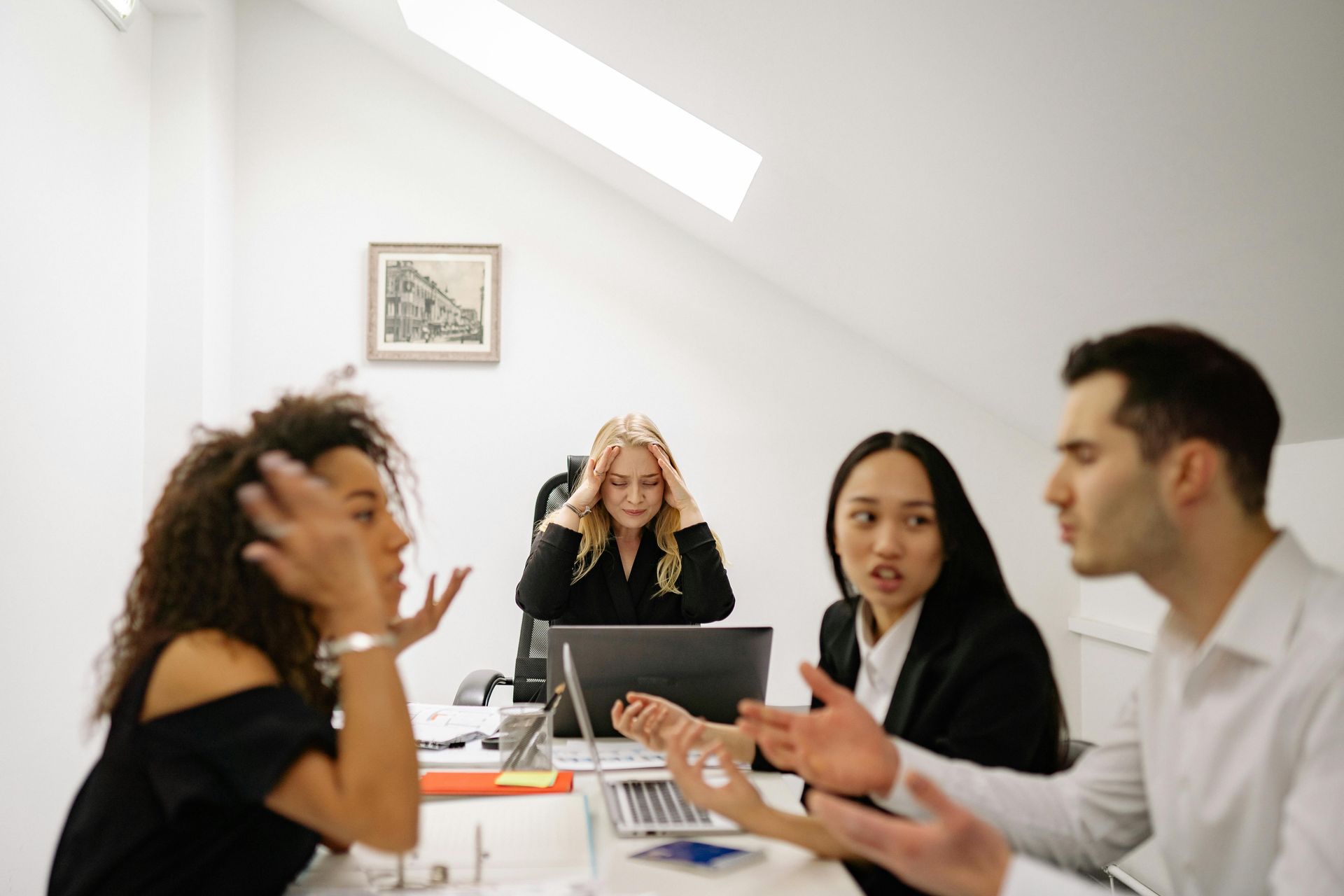 A group of people are sitting around a table having a meeting.