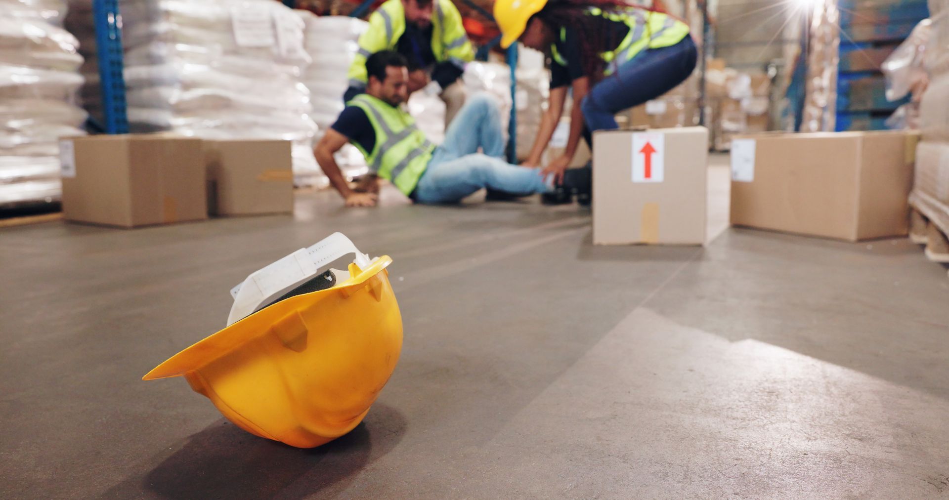 A group of construction workers are falling in a warehouse.