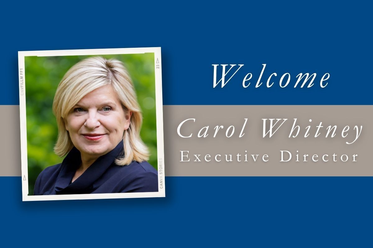A picture of carol whitney executive director on a blue background