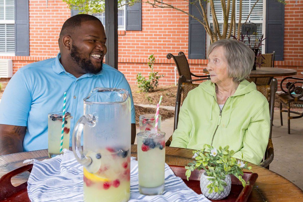A man and a woman are sitting at a table drinking lemonade.