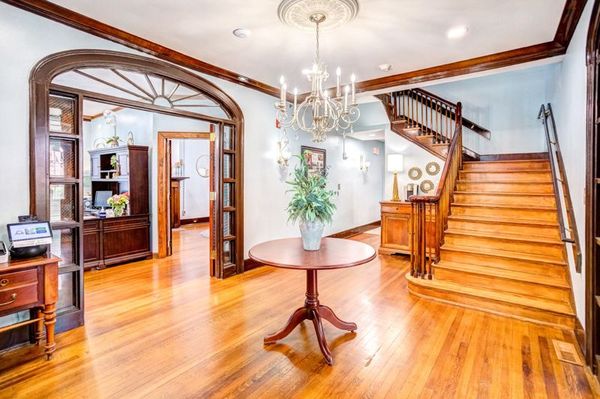 There is a table and stairs in the middle of the room.