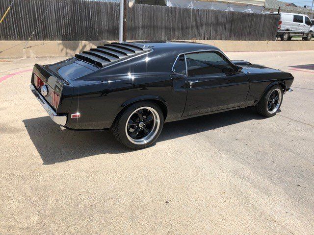 Window Tint Black Car — Side View of a Black Tinted Car in Lewisville, Texas