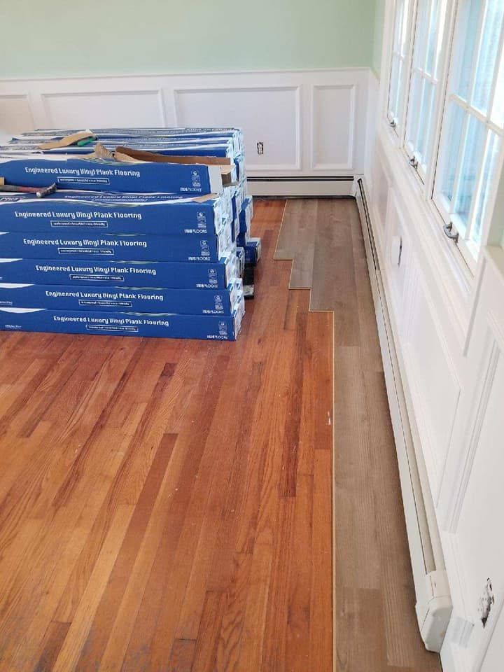 A stack of boxes sitting on top of a wooden floor.