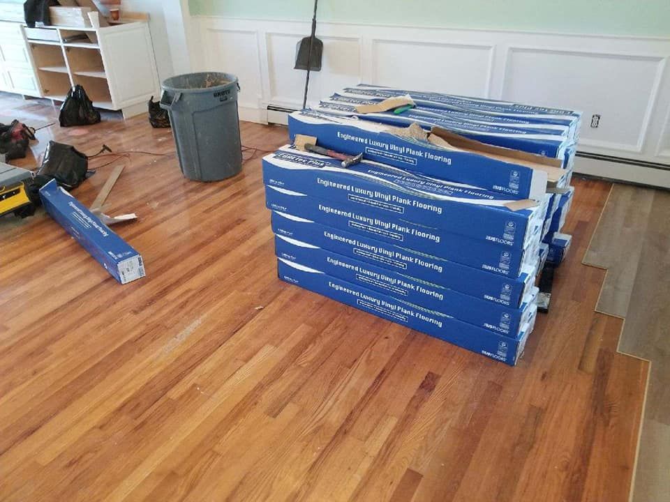 A stack of boxes sitting on top of a wooden floor.