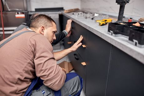 Handyman making kitchen wall cabinets
