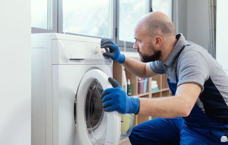 Professional technician checking a washing machine