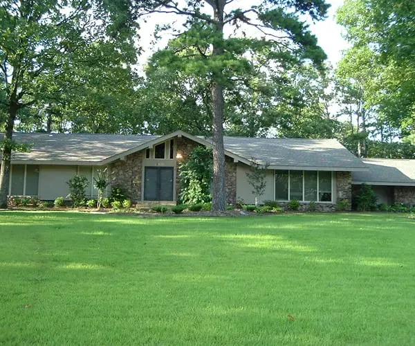 A house with a large lawn in front of it