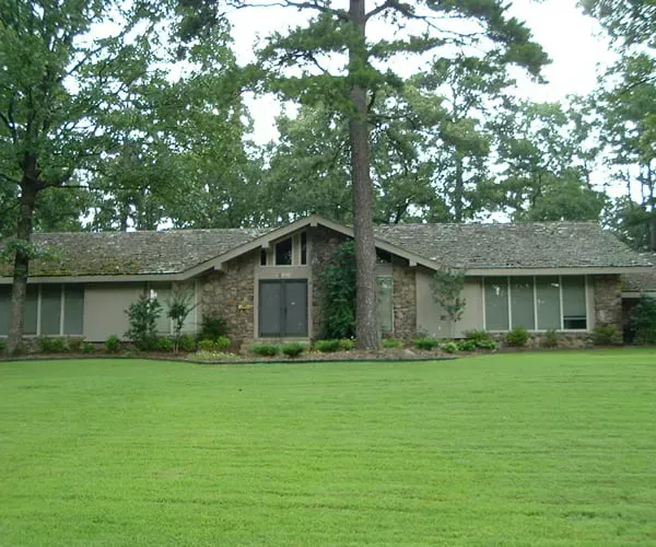 A house with a large lawn in front of it