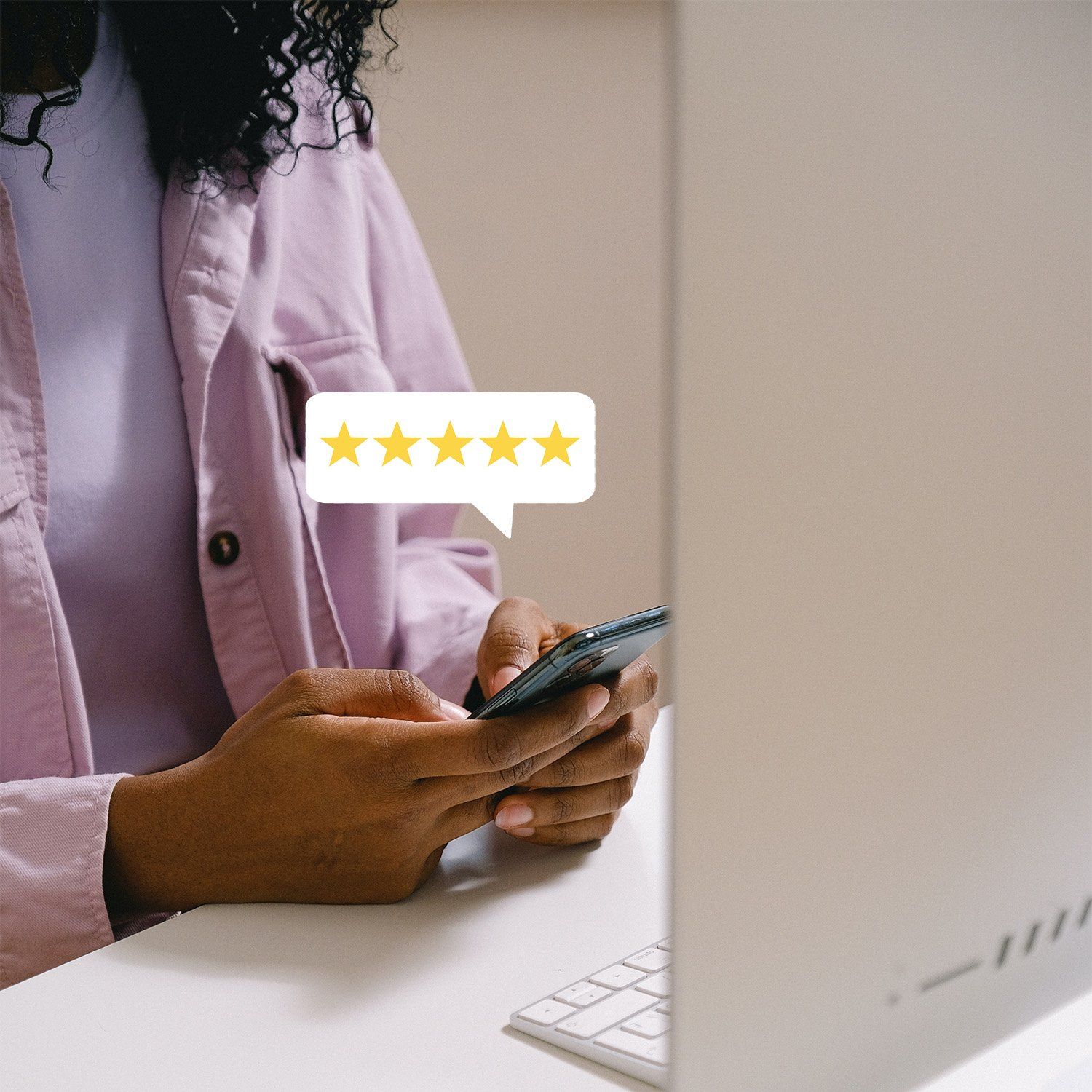 Person typing on phone and 5 stars above the phone