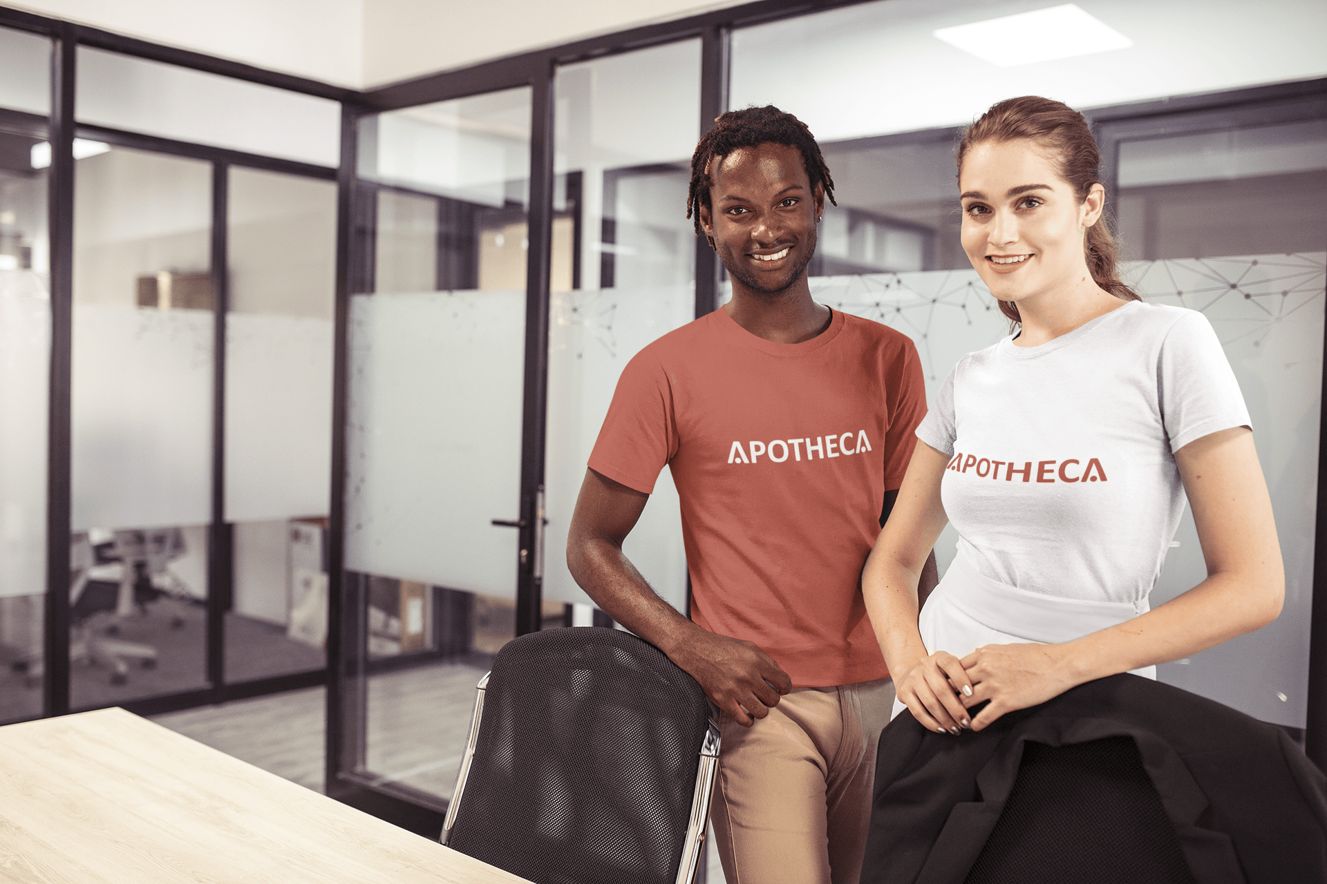A man and a woman are standing next to each other in an office.
