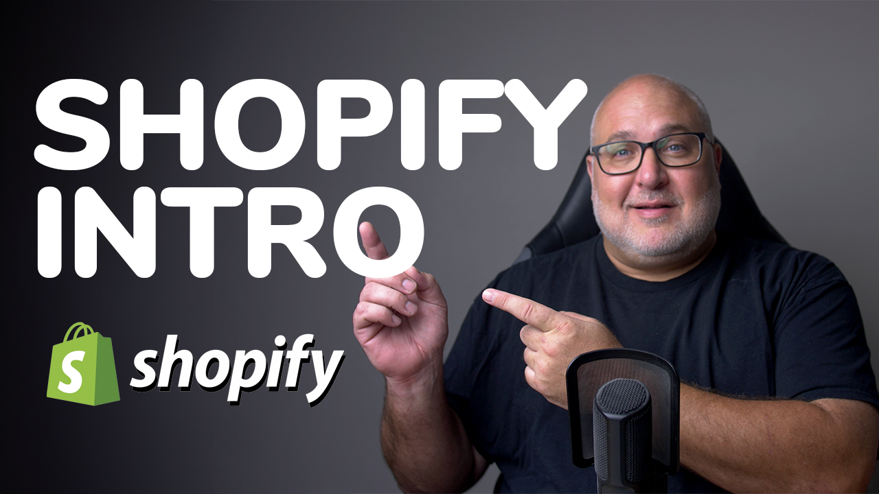 A man with glasses is pointing at a shopify logo
