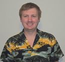 A man wearing a shirt with palm trees on it