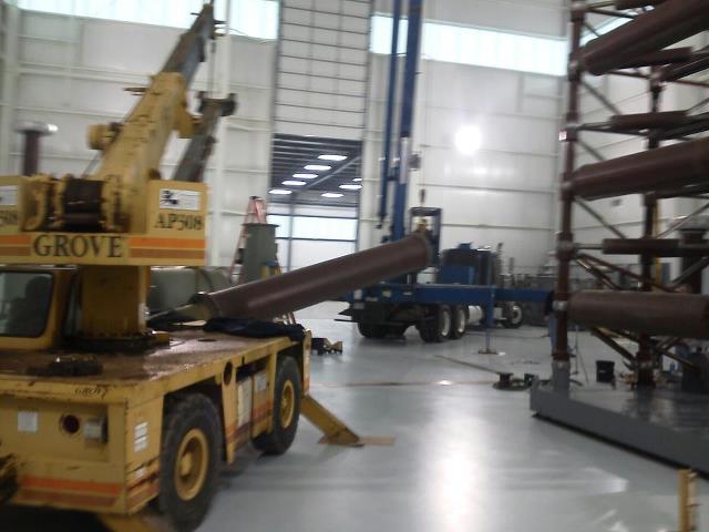Crane Movers — Crane Lifting a Tube in Monroe, NC