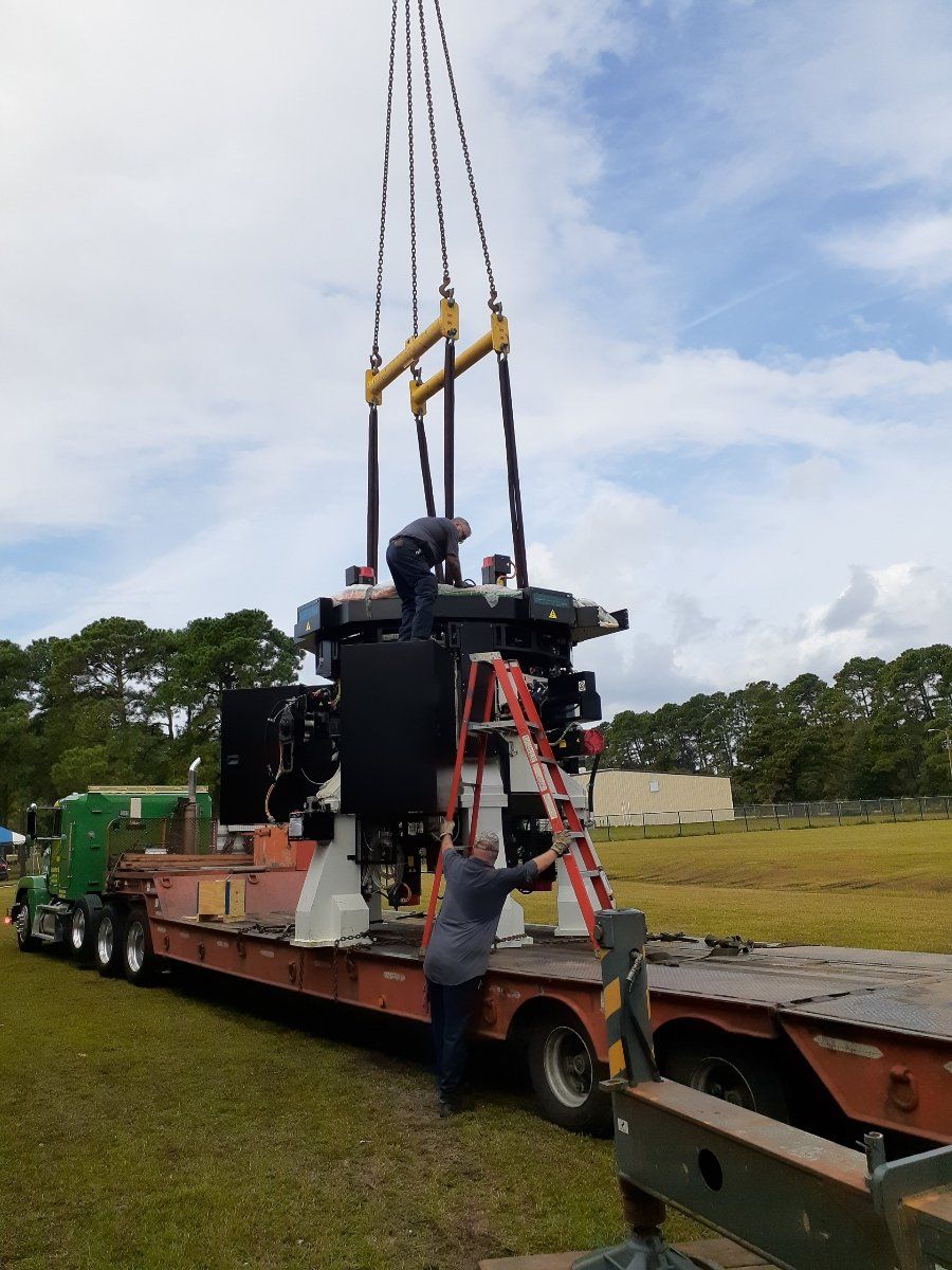 Crane Movers — Crane Lifting a Tube in Monroe, NC