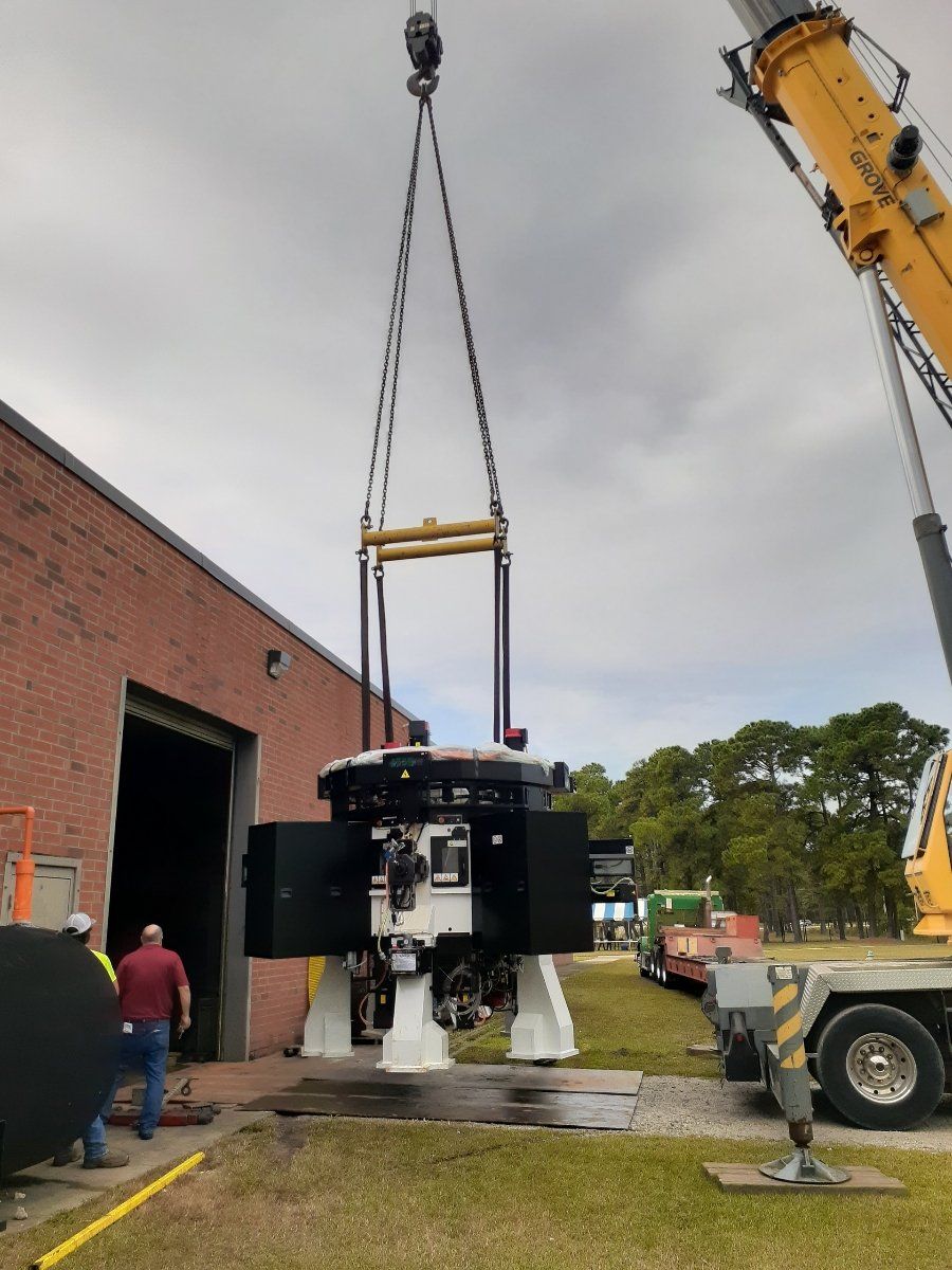 Plant Relocation Movers — Crane Moving Large Metal Object in Monroe, NC