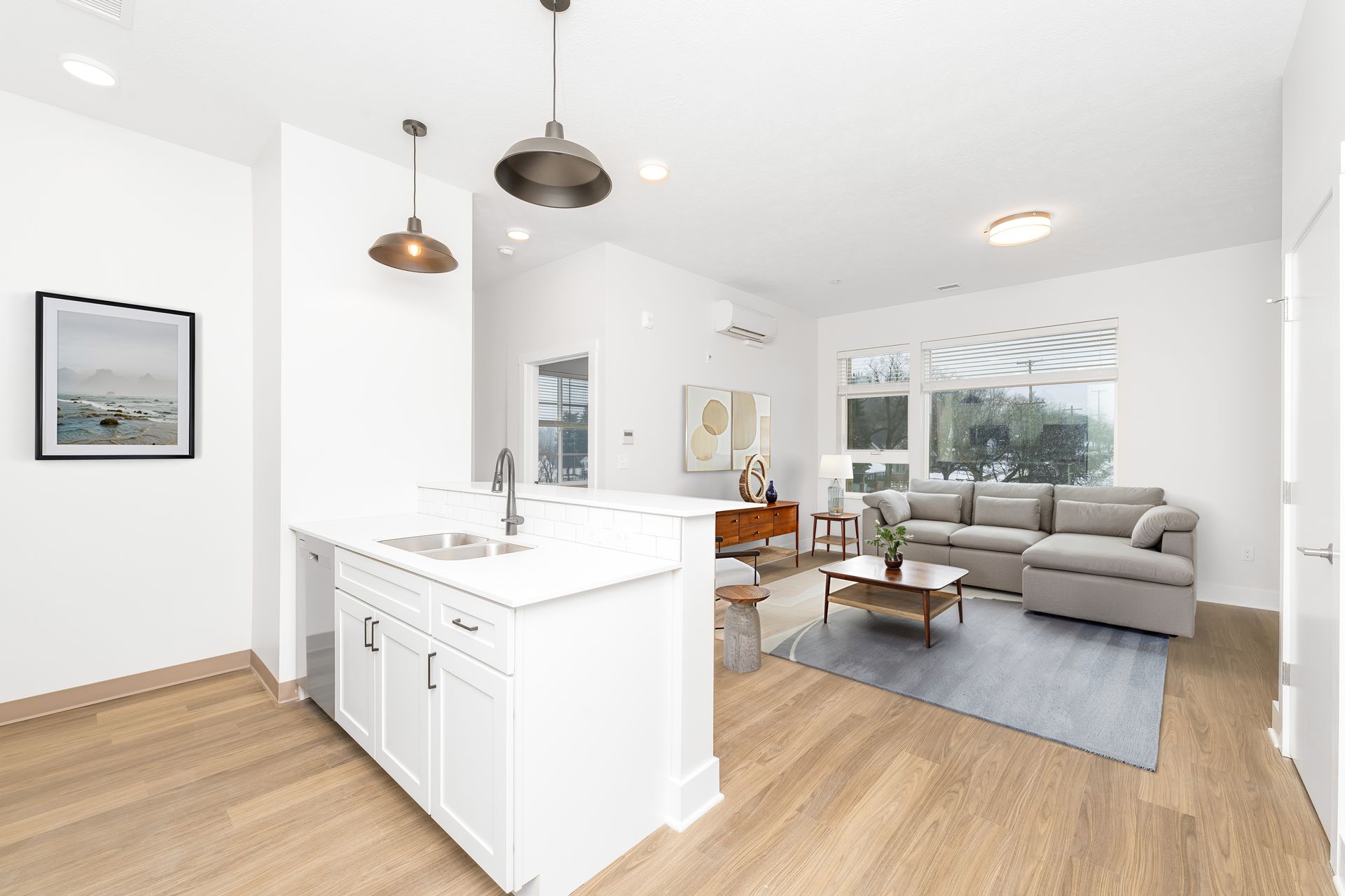 Virtually staged kitchen and main area of a newly constructed 1-bedroom apartment for rent. 