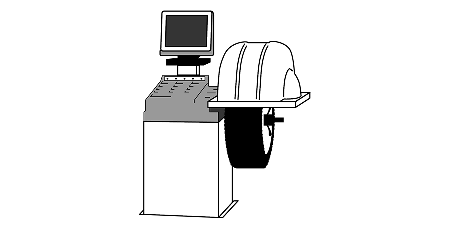 A black and white drawing of a computer and a wheel balancer.